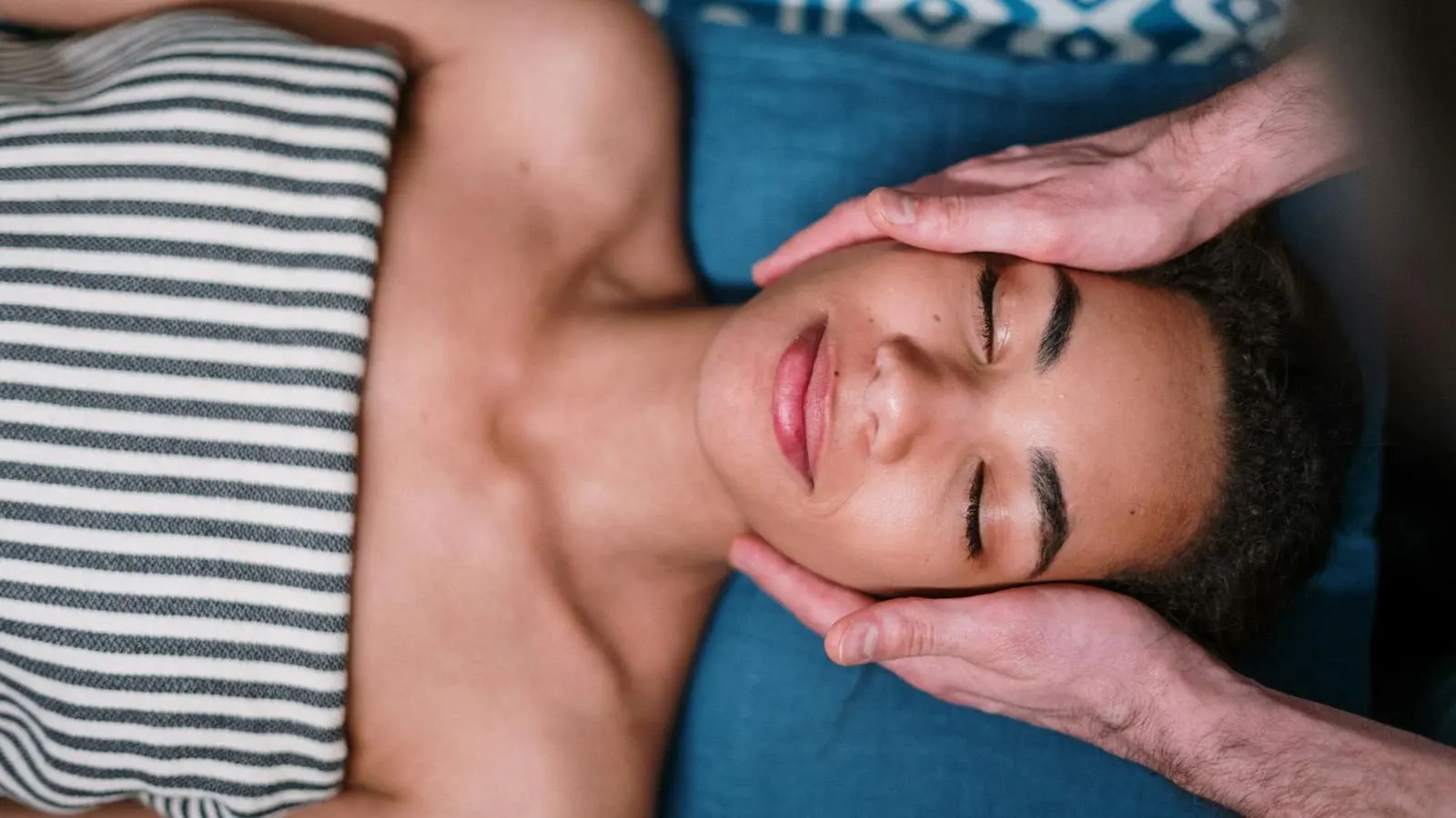 Mains expertes appliquant un massage doux du visage, geste apaisant et professionnel